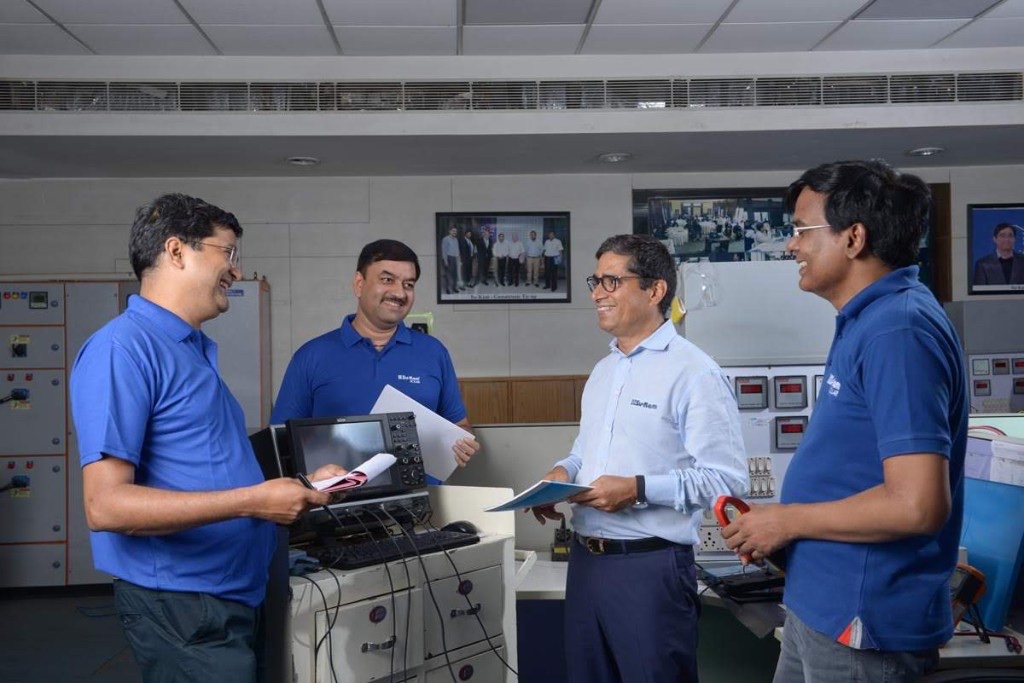 Kunwer Sachdev with the Su-Kam engineering team in a technology research lab, showcasing innovation and patent development