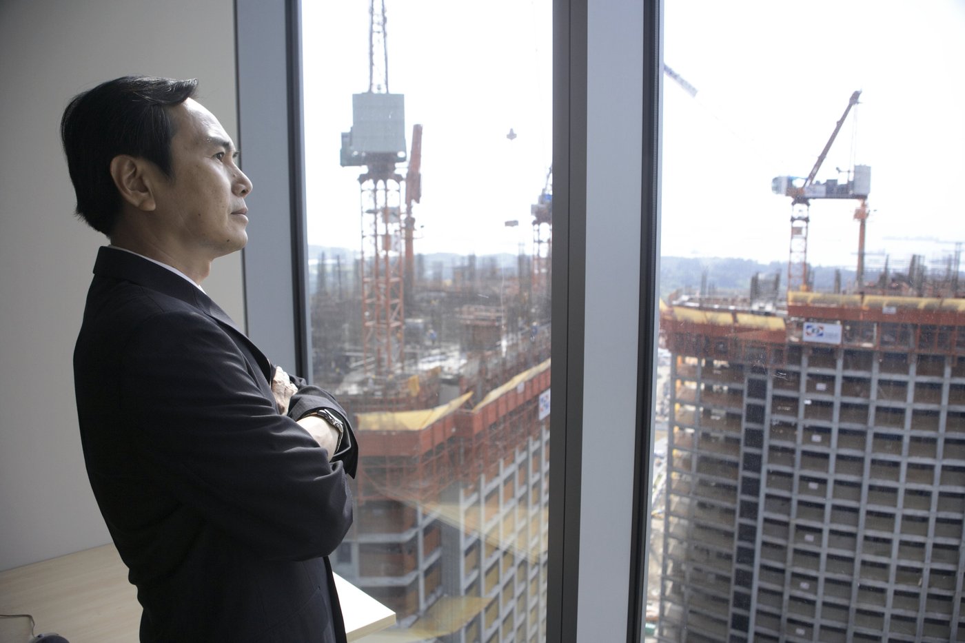 Kunwer Sachdev looking out at a construction site — visualising the future